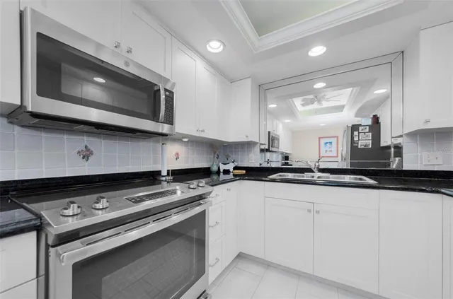 a kitchen with stainless steel appliances a sink dishwasher stove and microwave