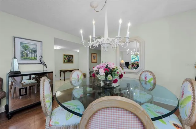 a view of a dining room with furniture a rug and wooden floor