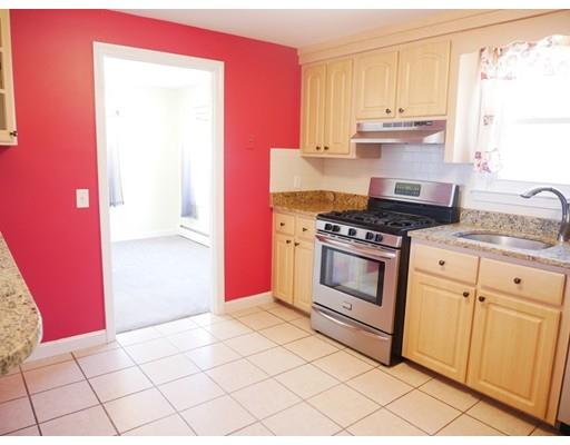 180 Mill Road Chelmsford, MA 01824 - Photo 14 of 30 a kitchen with granite countertop a stove top oven cabinets and a counter top space