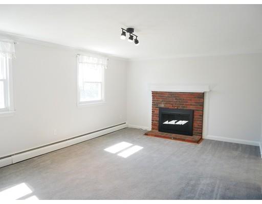180 Mill Road Chelmsford, MA 01824 - Photo 2 of 30 an empty room with a fireplace and windows