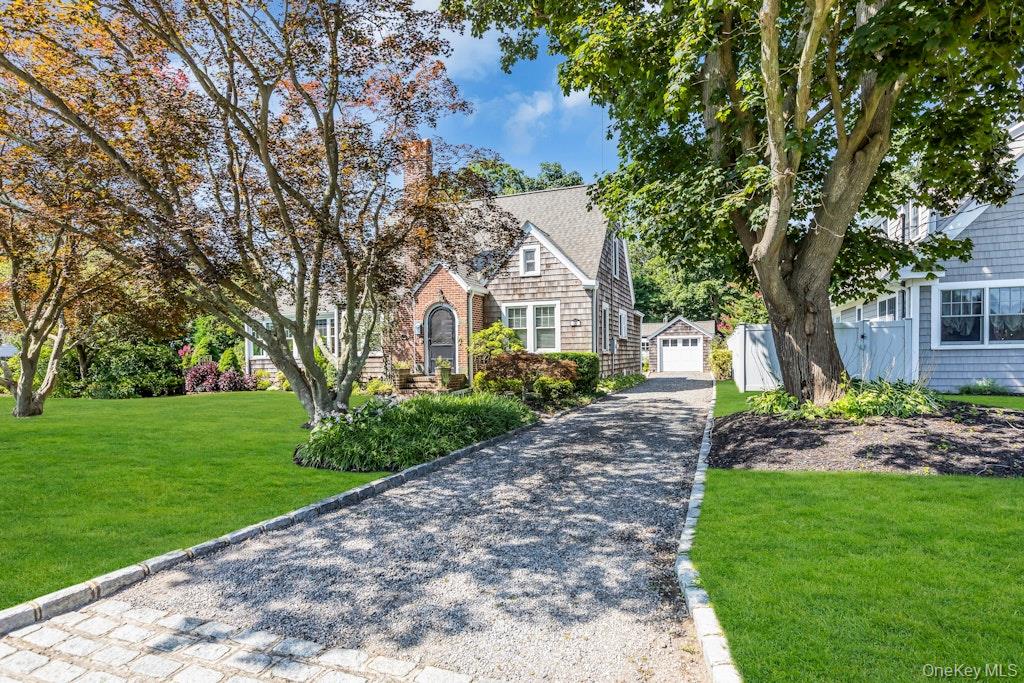 32 Paumanake Road Blue Point, NY 11715 - Photo 1 of 1 a front view of a house with a garden