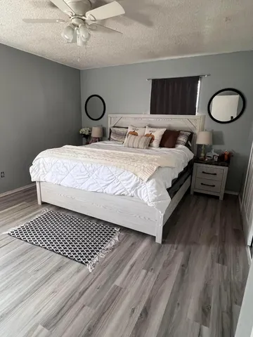 a bedroom with a bed and wooden floor