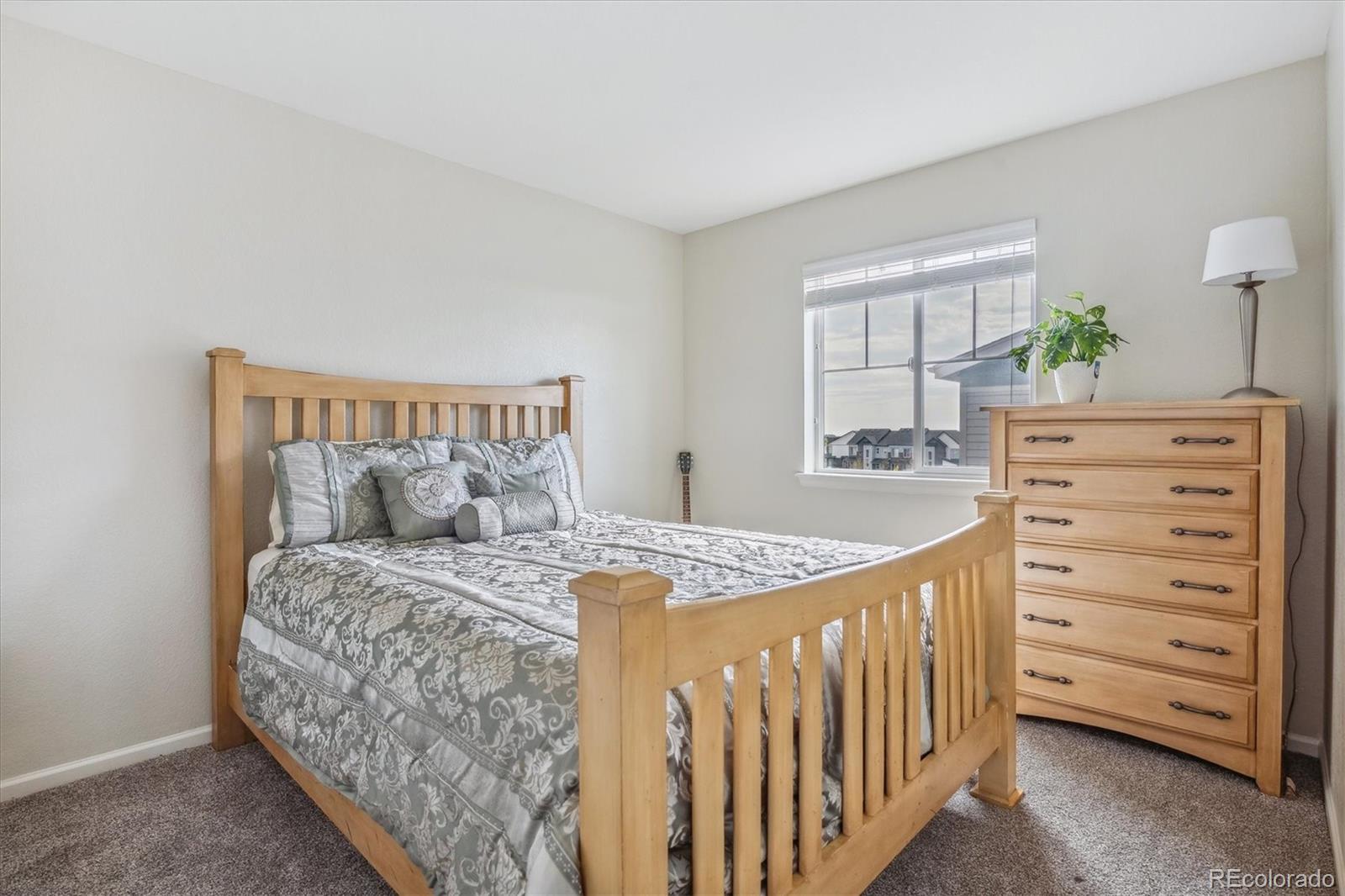 19955 West 93rd Avenue Arvada, CO 80007 - Photo 12 of 33 a bedroom with a bed and a dresser