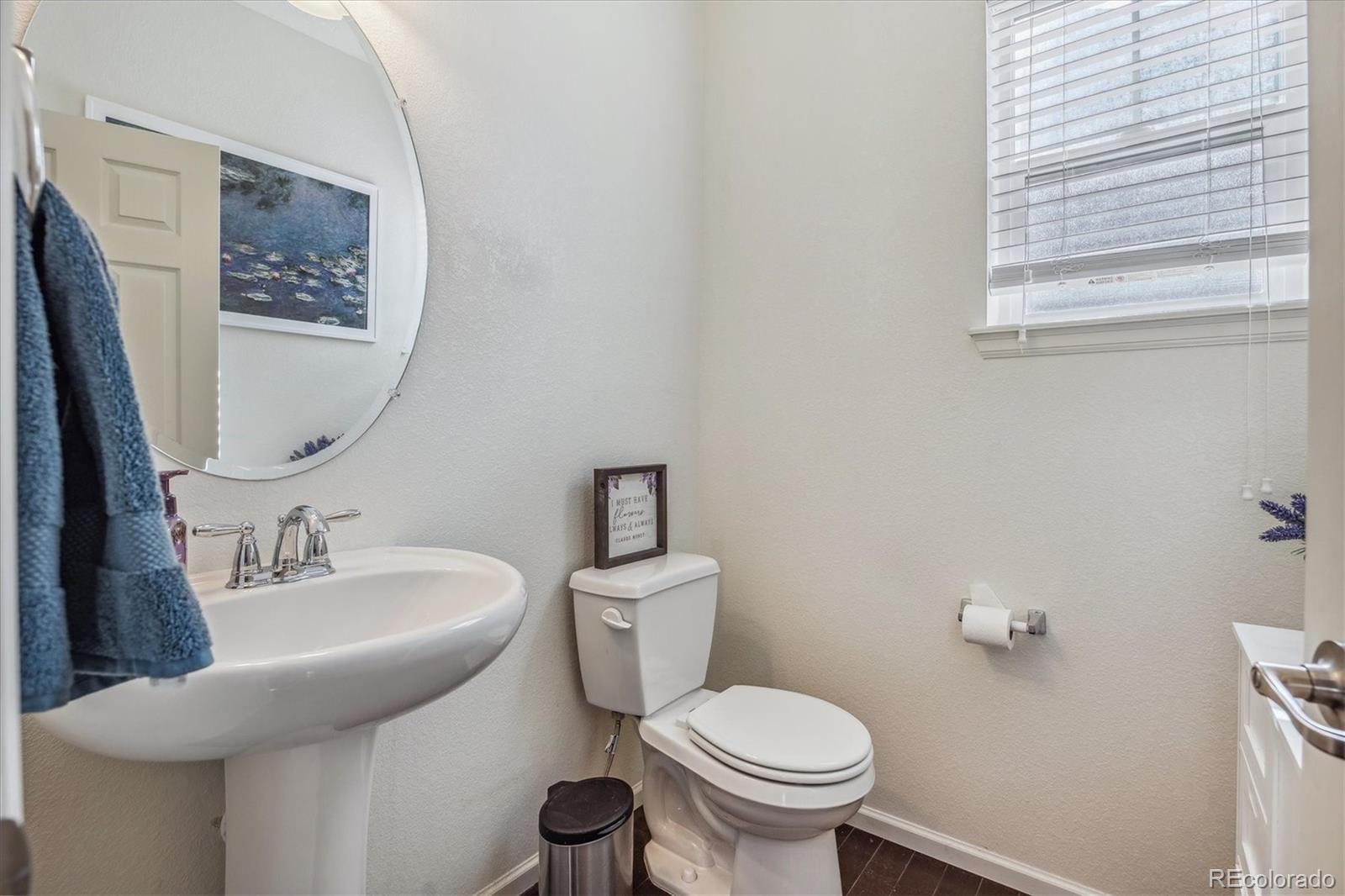 19955 West 93rd Avenue Arvada, CO 80007 - Photo 13 of 33 a bathroom with a toilet sink and mirror