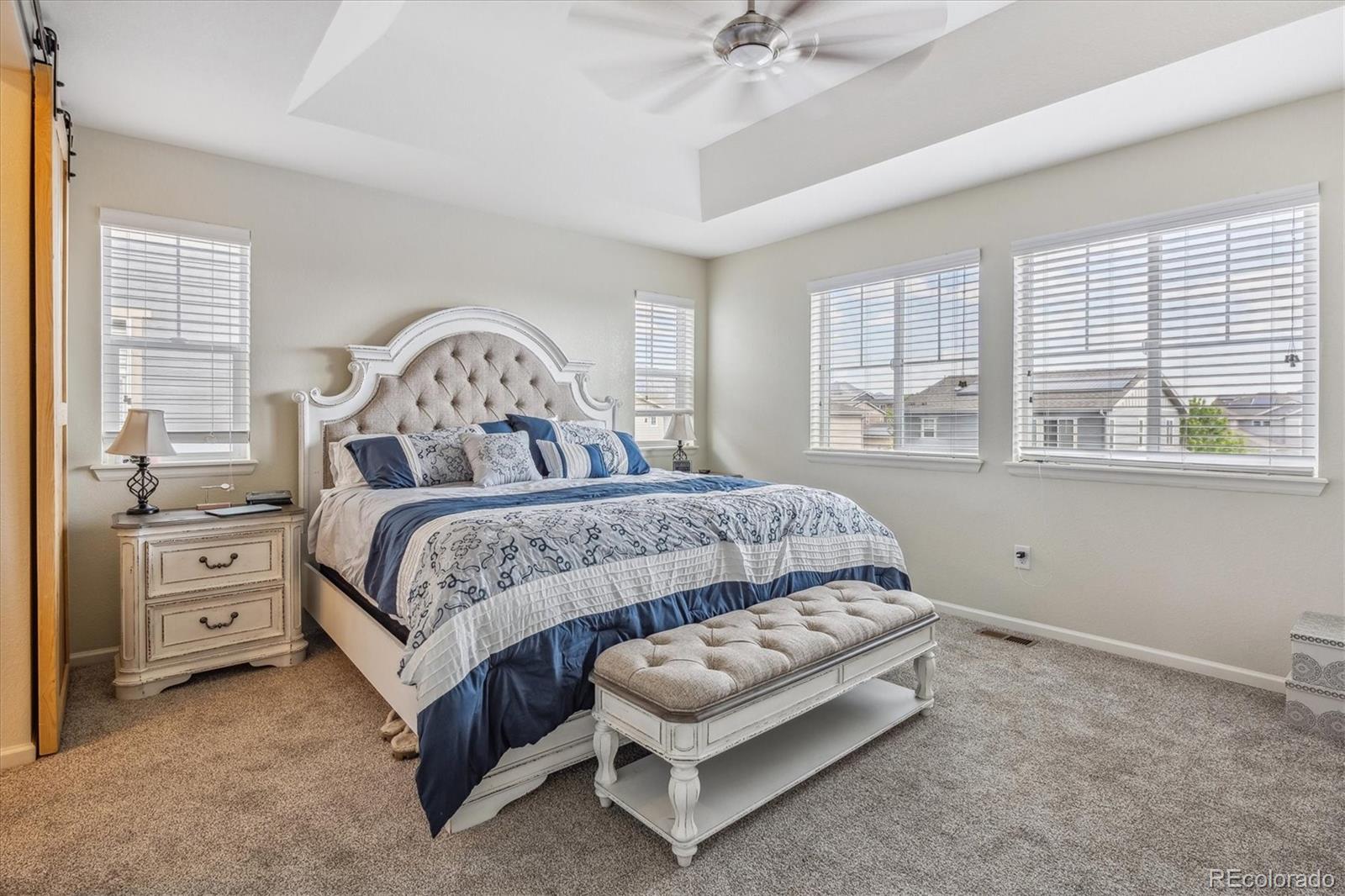 19955 West 93rd Avenue Arvada, CO 80007 - Photo 18 of 33 a bedroom with a bed and a dresser