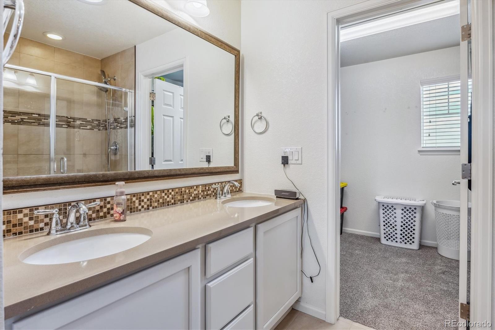 19955 West 93rd Avenue Arvada, CO 80007 - Photo 19 of 33 a bathroom with a sink and a mirror