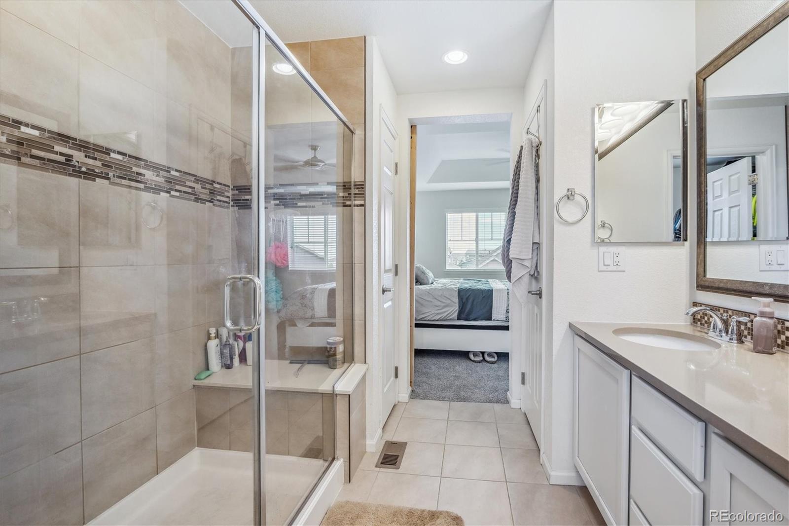 19955 West 93rd Avenue Arvada, CO 80007 - Photo 20 of 33 a bathroom with a double vanity sink toilet and shower