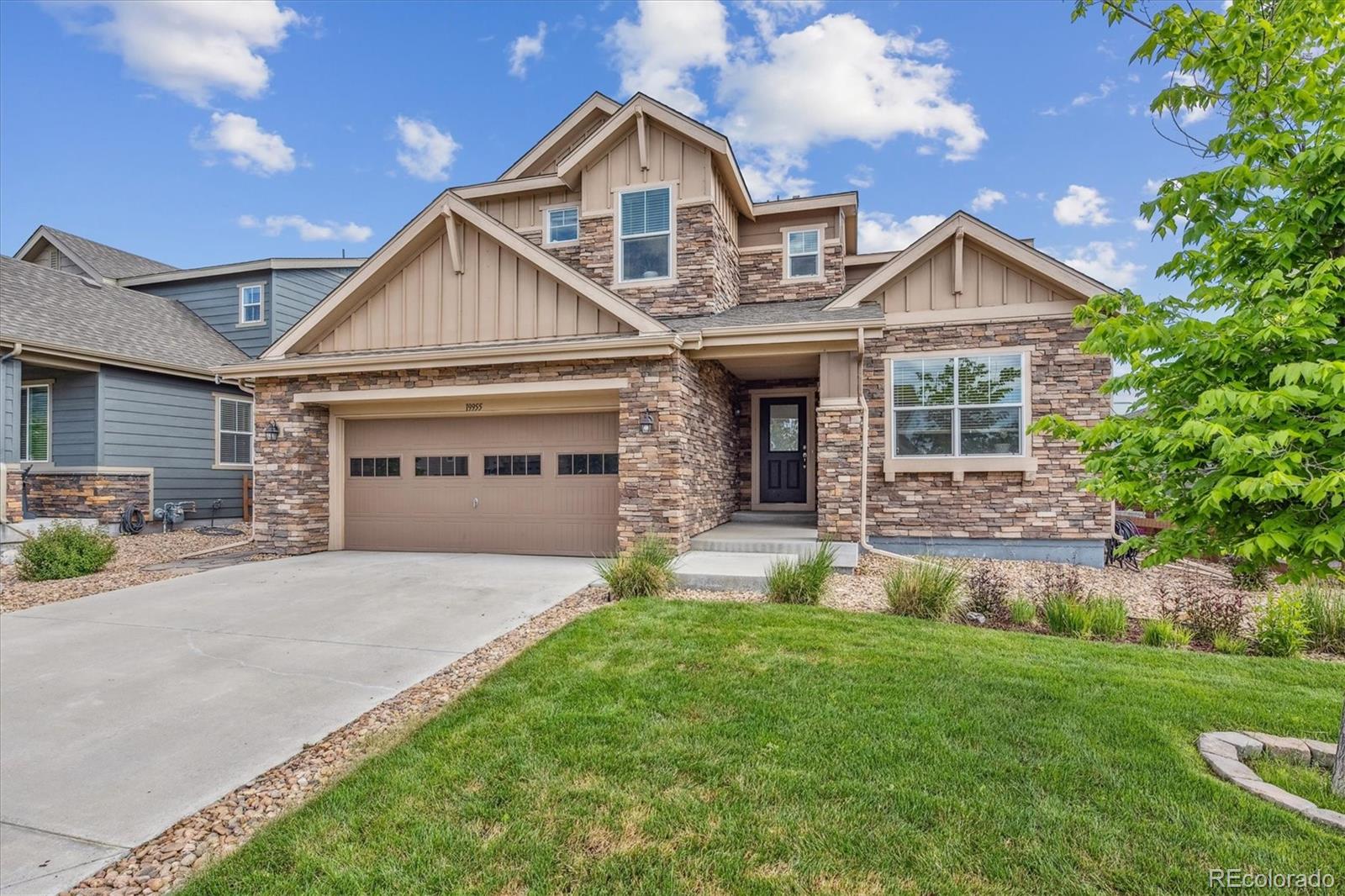 19955 West 93rd Avenue Arvada, CO 80007 - Photo 2 of 33 a front view of a house with a yard and garage