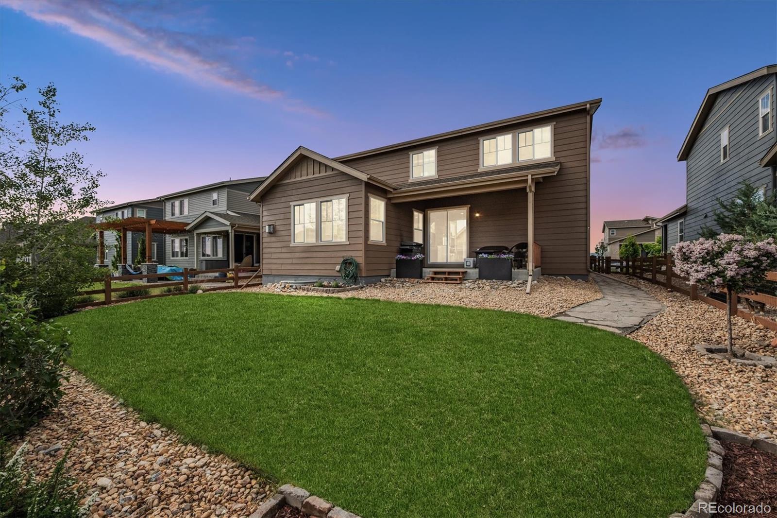 19955 West 93rd Avenue Arvada, CO 80007 - Photo 22 of 33 a front view of a house with a yard