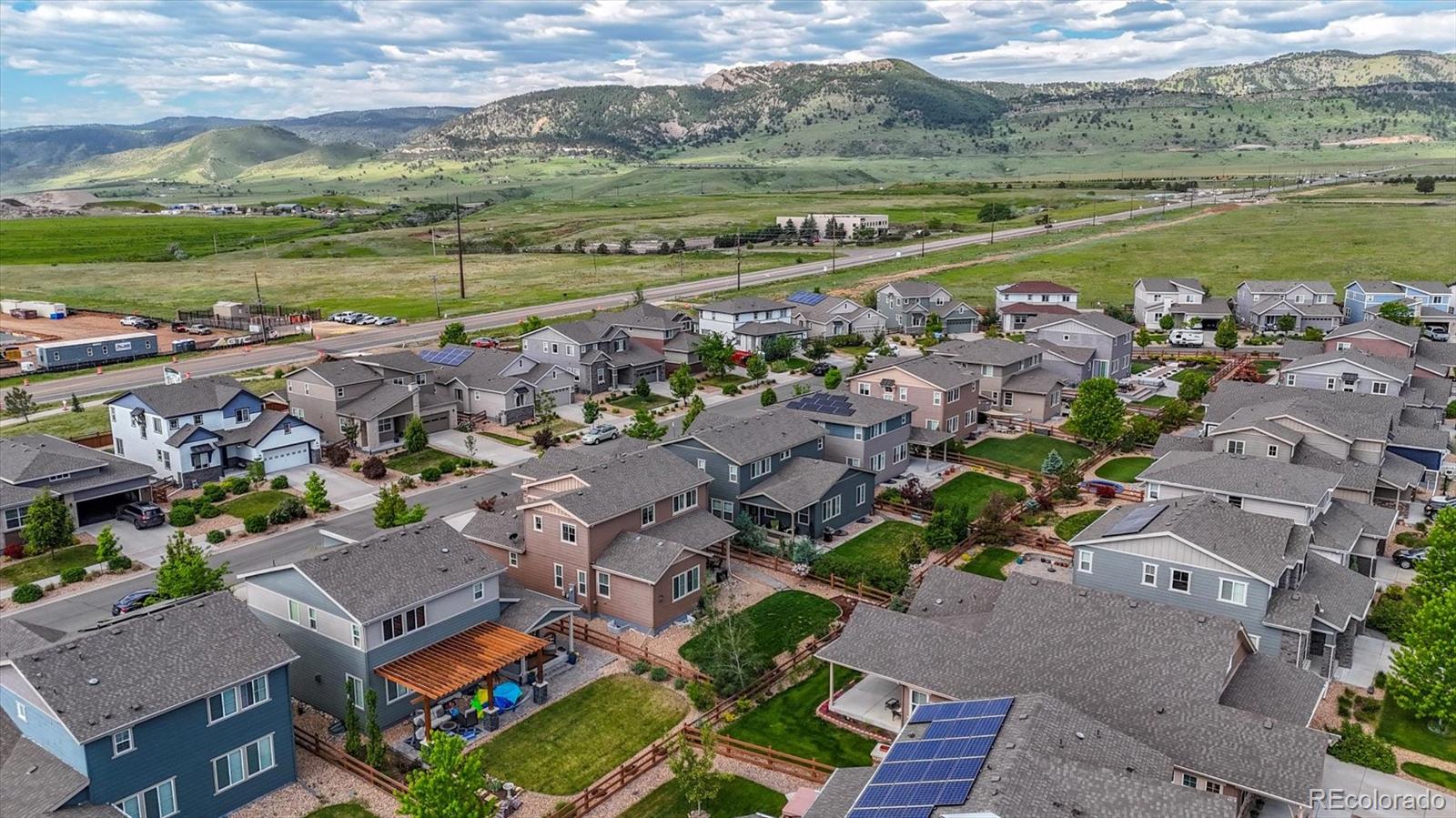 19955 West 93rd Avenue Arvada, CO 80007 - Photo 26 of 33 an aerial view of a city with lots of residential buildings and lake view
