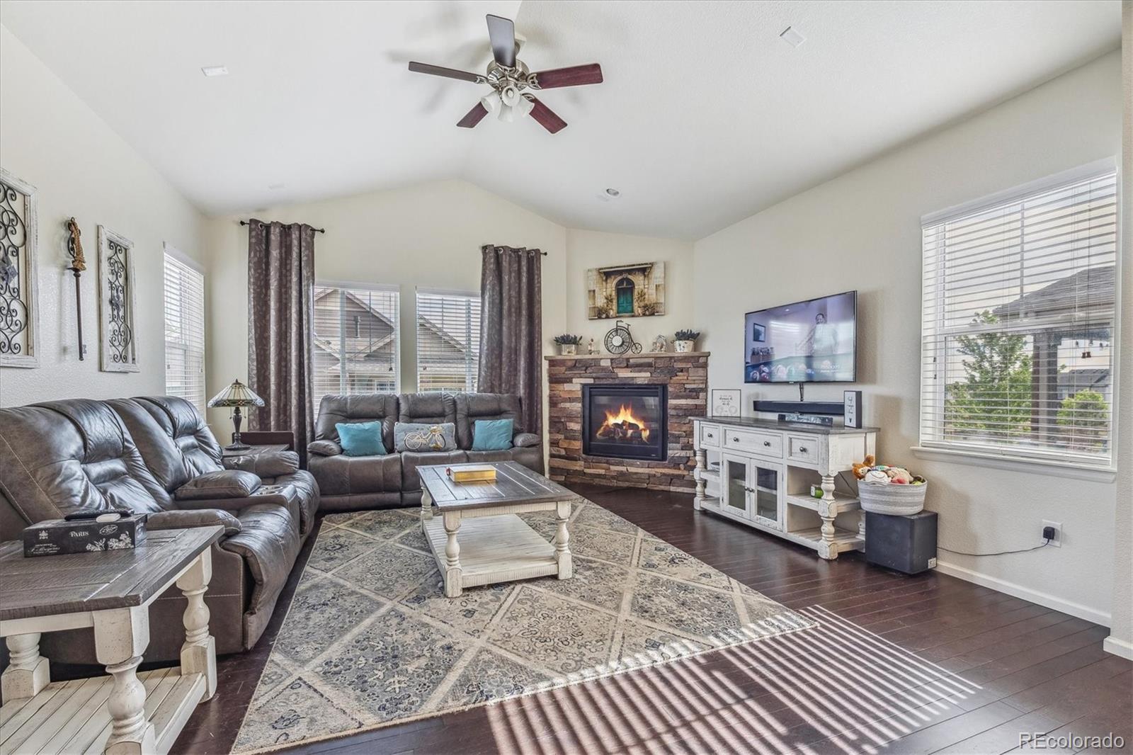 19955 West 93rd Avenue Arvada, CO 80007 - Photo 4 of 33 a living room with furniture large window and a flat screen tv