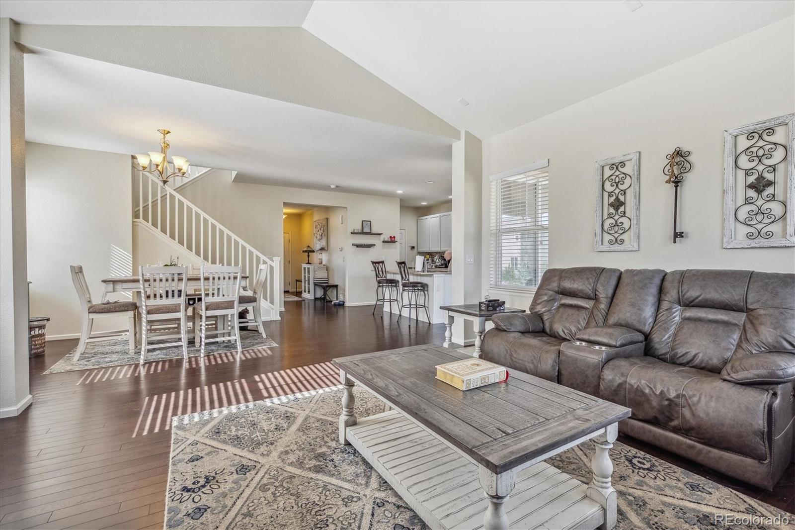 19955 West 93rd Avenue Arvada, CO 80007 - Photo 6 of 33 a living room with furniture a wooden floor and a rug