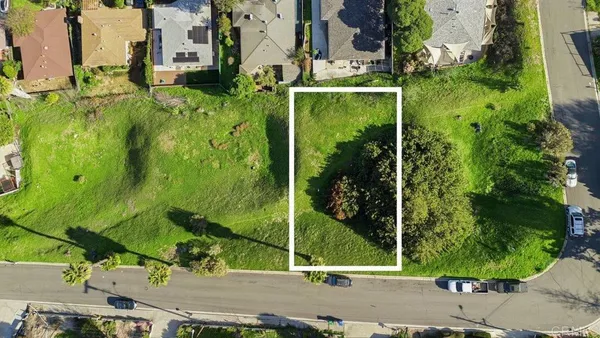 an aerial view of residential houses with outdoor space and street view