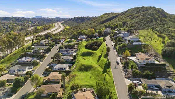 an aerial view of residential houses with outdoor space