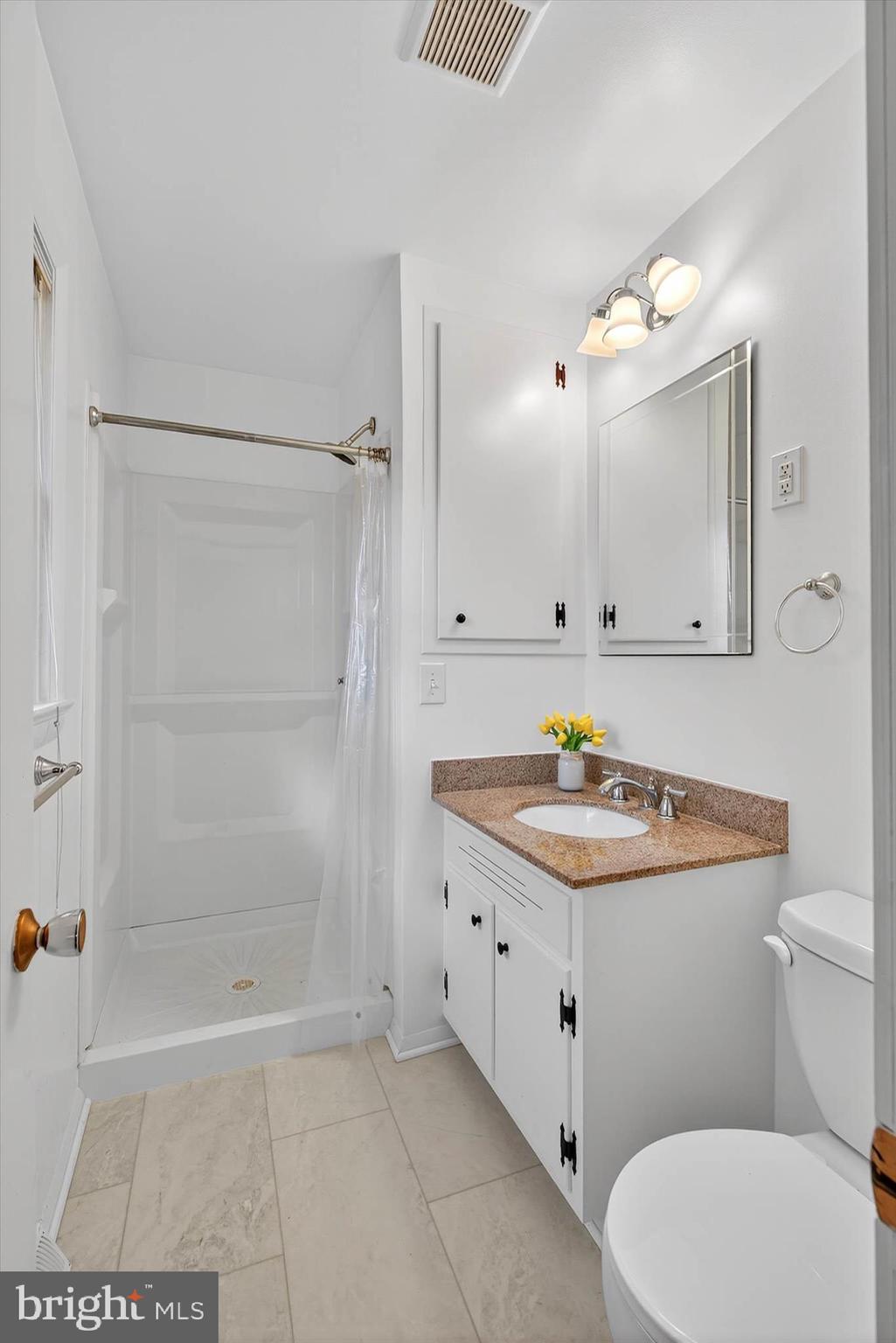 444 Biscayne Road Lancaster, PA 17601 - Photo 22 of 57 a bathroom with a sink a toilet a mirror and shower