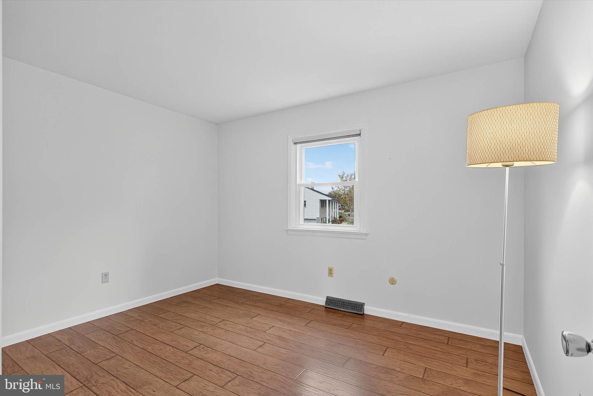 444 Biscayne Road Lancaster, PA 17601 - Photo 26 of 57 a view of an empty room with wooden floor and a lamp