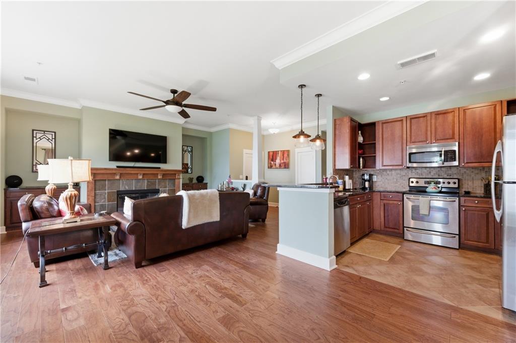 117 South Bay Road, Unit 402 Eatonton, GA 31024 - Photo 30 of 48 a large living room with stainless steel appliances granite countertop a couch and a living room view