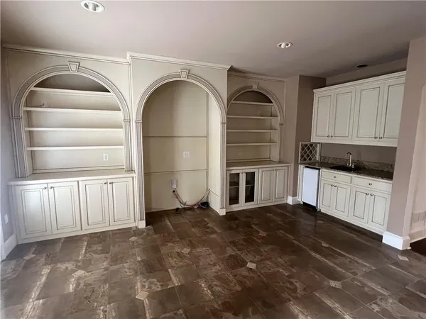 a view of a kitchen with cabinet and refrigerator