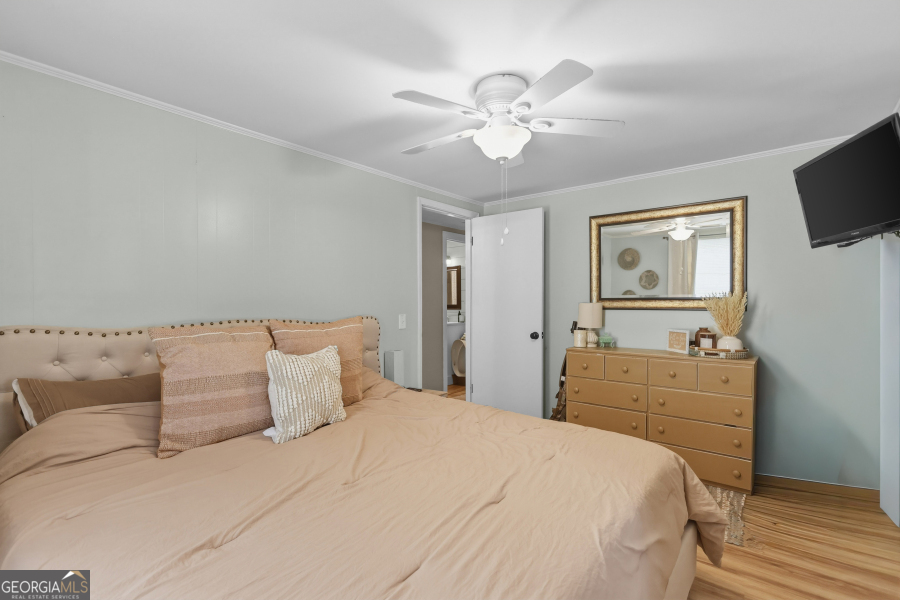 120 Carter Street Jesup, GA 31545 - Photo 11 of 27 a bedroom with a bed and a chandelier