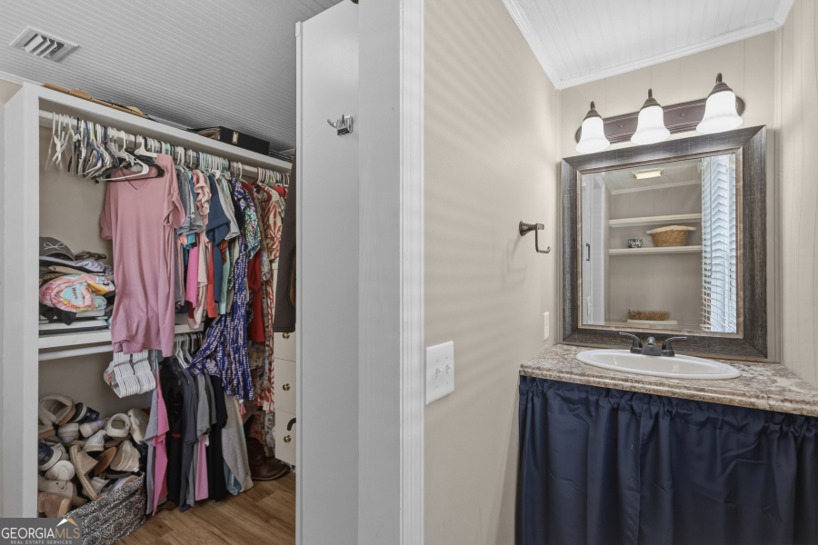 120 Carter Street Jesup, GA 31545 - Photo 13 of 27 a view of walk in closet with clothes