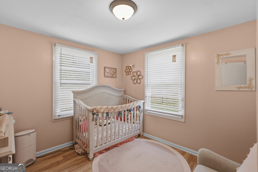 120 Carter Street Jesup, GA 31545 - Photo 15 of 27 a bedroom with a bed and wooden floor
