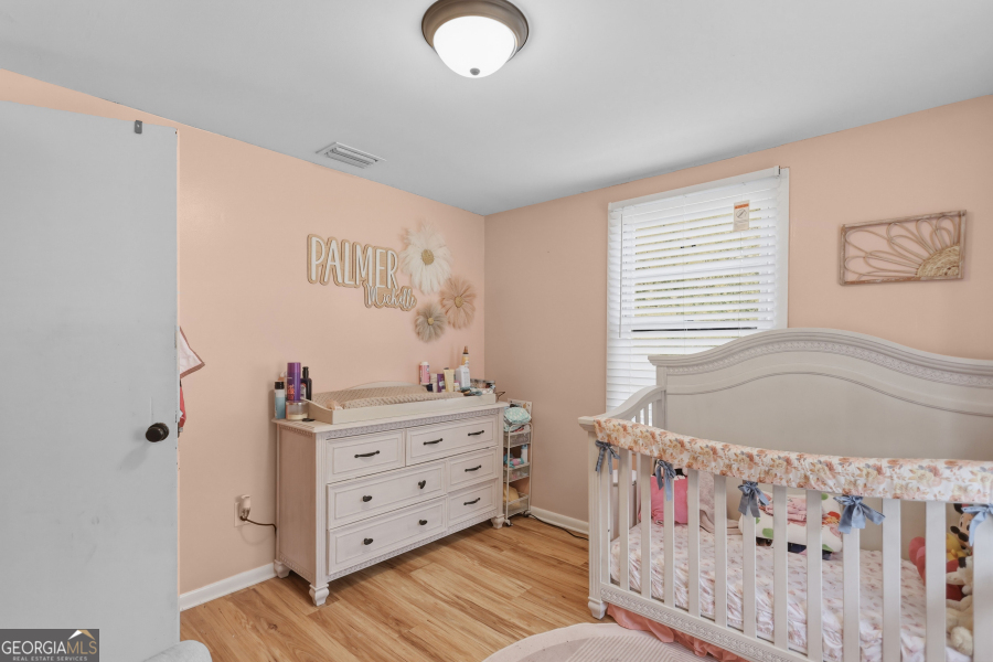 120 Carter Street Jesup, GA 31545 - Photo 16 of 27 a bedroom with a bed and a window