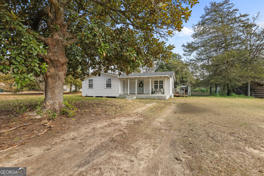 120 Carter Street Jesup, GA 31545 - Photo 23 of 27 a house with trees in front of it
