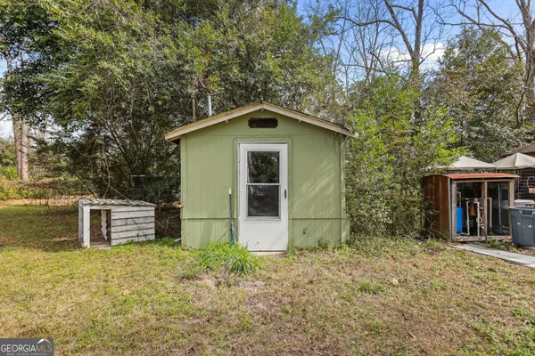 front view of a house with a yard and an trees