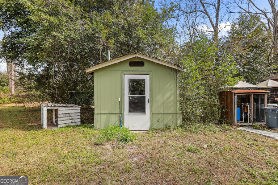 120 Carter Street Jesup, GA 31545 - Photo 24 of 27 front view of a house with a yard and an trees
