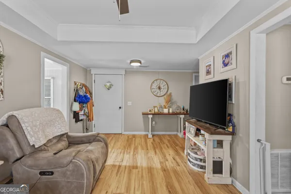 a living room with furniture and a flat screen tv