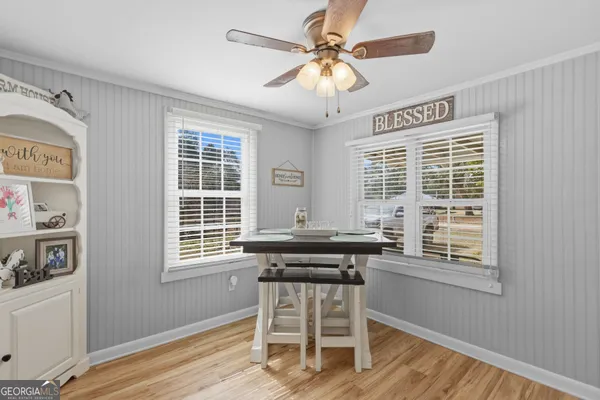 a view of a dining room with furniture window and wooden floor