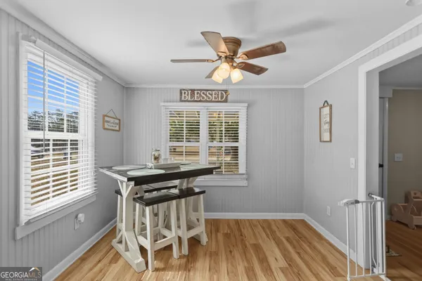 a view of a dining room with furniture window and wooden floor
