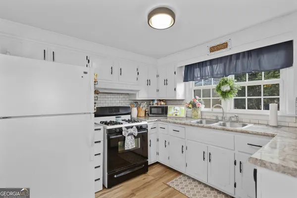 a kitchen with a sink stove and window