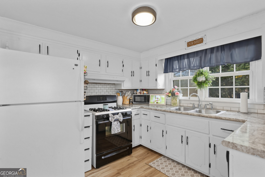120 Carter Street Jesup, GA 31545 - Photo 8 of 27 a kitchen with a sink stove and window