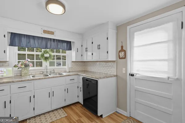 a kitchen with a sink cabinets and window