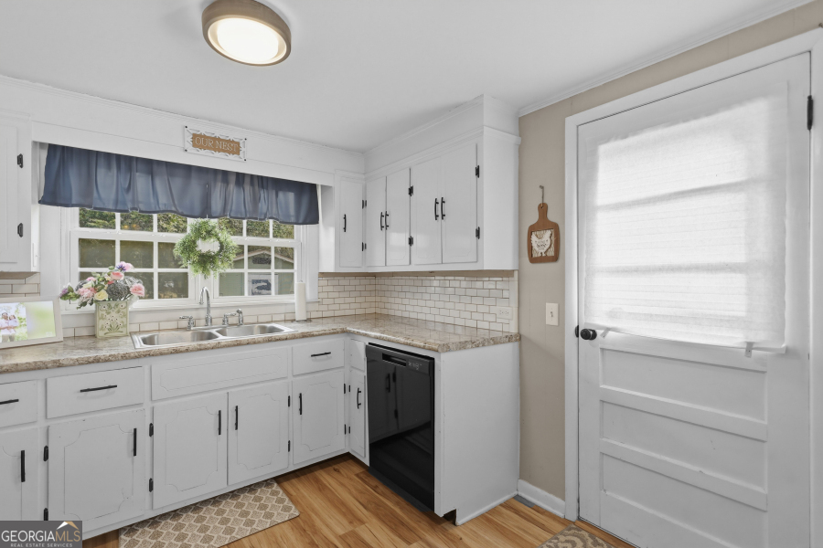 120 Carter Street Jesup, GA 31545 - Photo 9 of 27 a kitchen with a sink cabinets and window