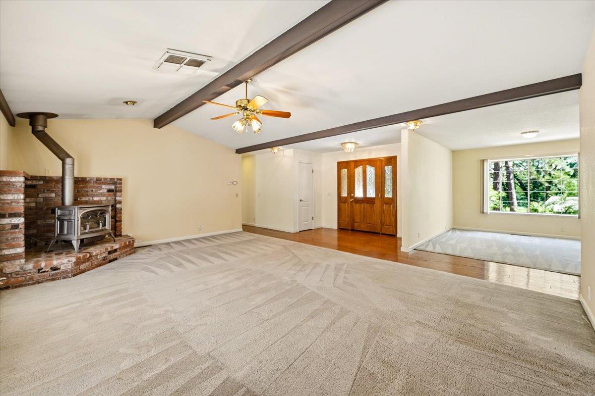 12600 Friar Tuck Road Grass Valley, CA 95949 - Photo 5 of 56 a view of an empty room with window and fireplace