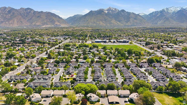 7872 Farm House Lane Midvale, UT 84047 - Photo 38 of 39 Residential neighborhood featuring a grid-pattern street layout, mature landscaping, and a mountainous backdrop