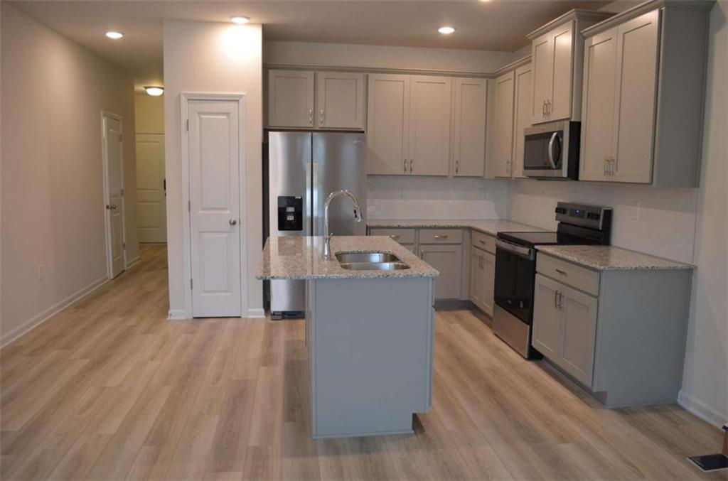 a kitchen with wooden cabinets and stainless steel appliances