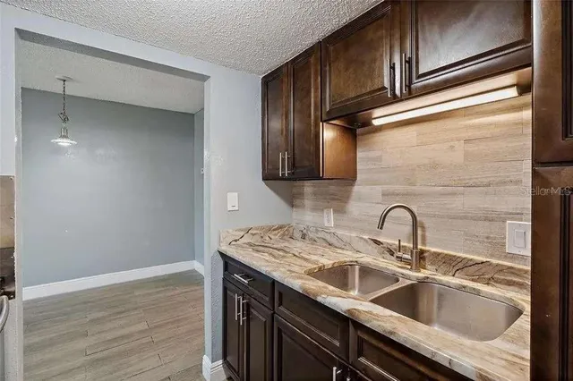 a close view of a sink a faucet and appliance in the kitchen