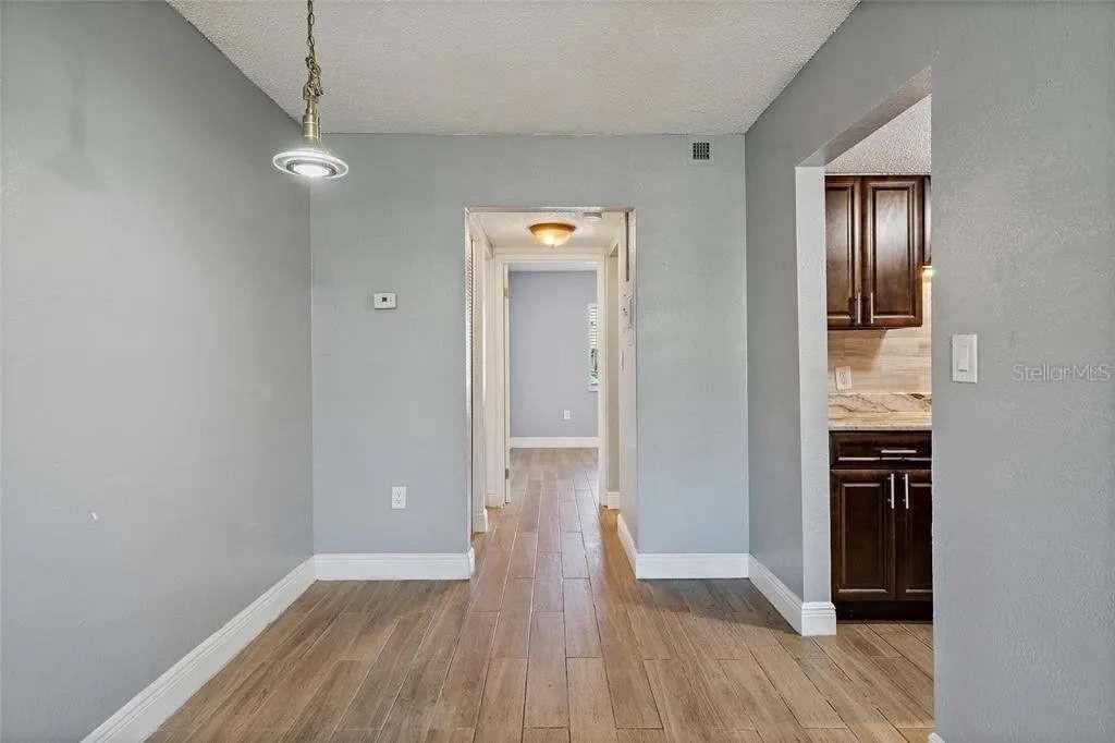 379 47th Avenue North, Unit 103 St. Petersburg, FL 33703 - Photo 16 of 24 wooden floor in an empty room with a window