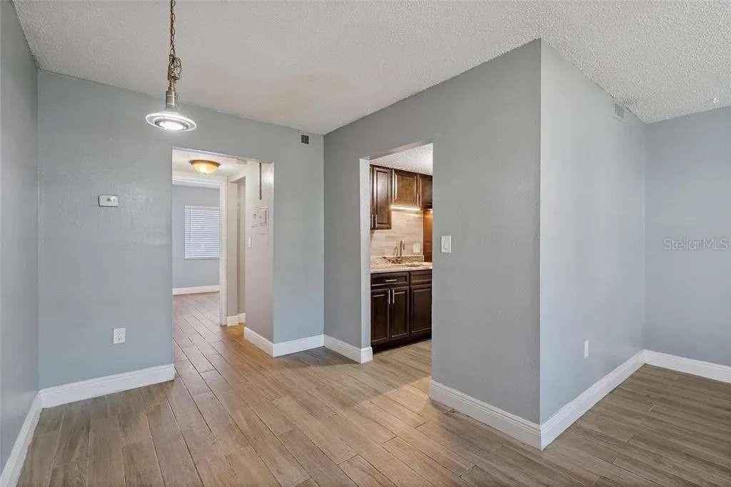 379 47th Avenue North, Unit 103 St. Petersburg, FL 33703 - Photo 17 of 24 a view of a room with wooden floor and windows