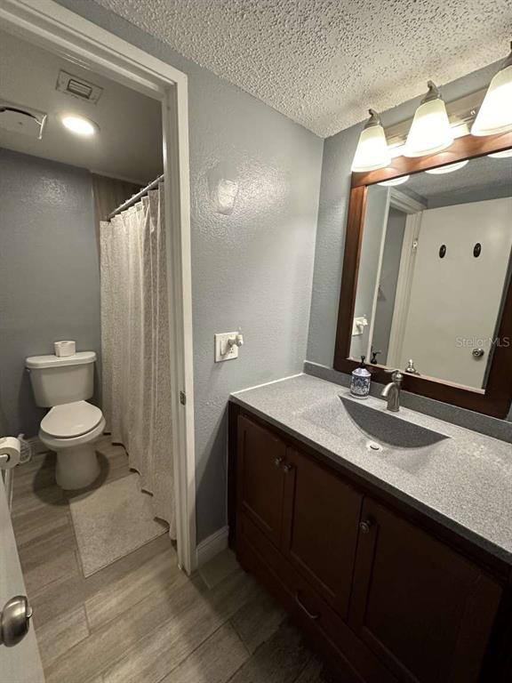 379 47th Avenue North, Unit 103 St. Petersburg, FL 33703 - Photo 19 of 24 a bathroom with a toilet sink and mirror