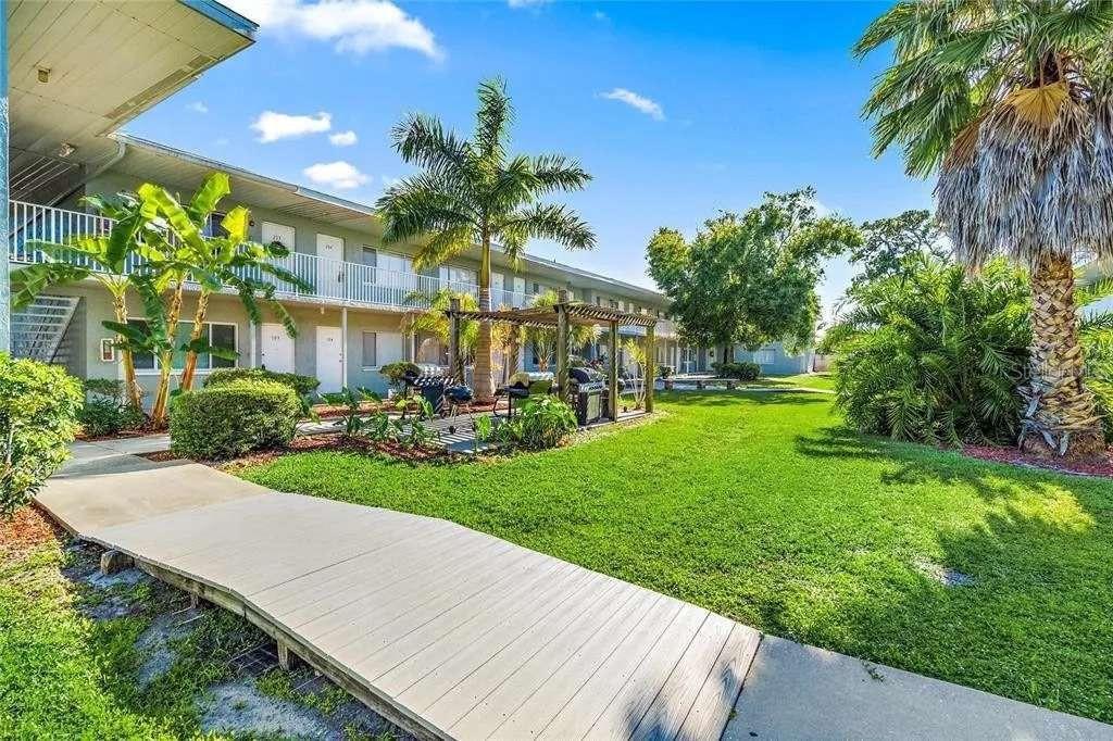379 47th Avenue North, Unit 103 St. Petersburg, FL 33703 - Photo 2 of 24 a front view of a house with garden