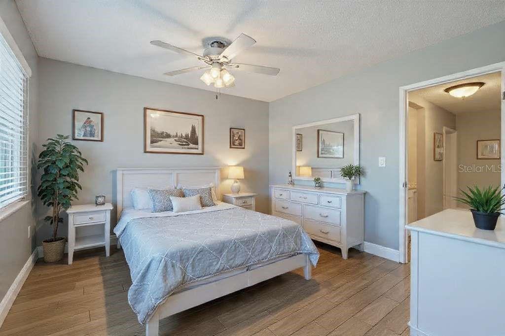 379 47th Avenue North, Unit 103 St. Petersburg, FL 33703 - Photo 21 of 24 a bedroom with a large bed and a chandelier