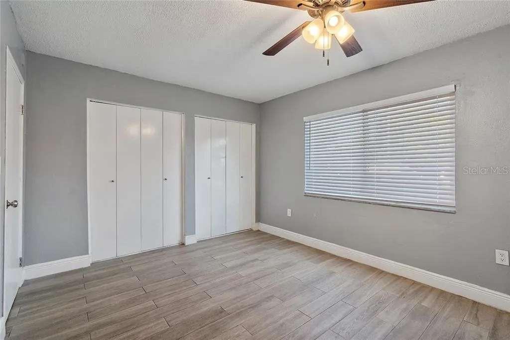 379 47th Avenue North, Unit 103 St. Petersburg, FL 33703 - Photo 23 of 24 a view of an empty room with wooden floor and a window