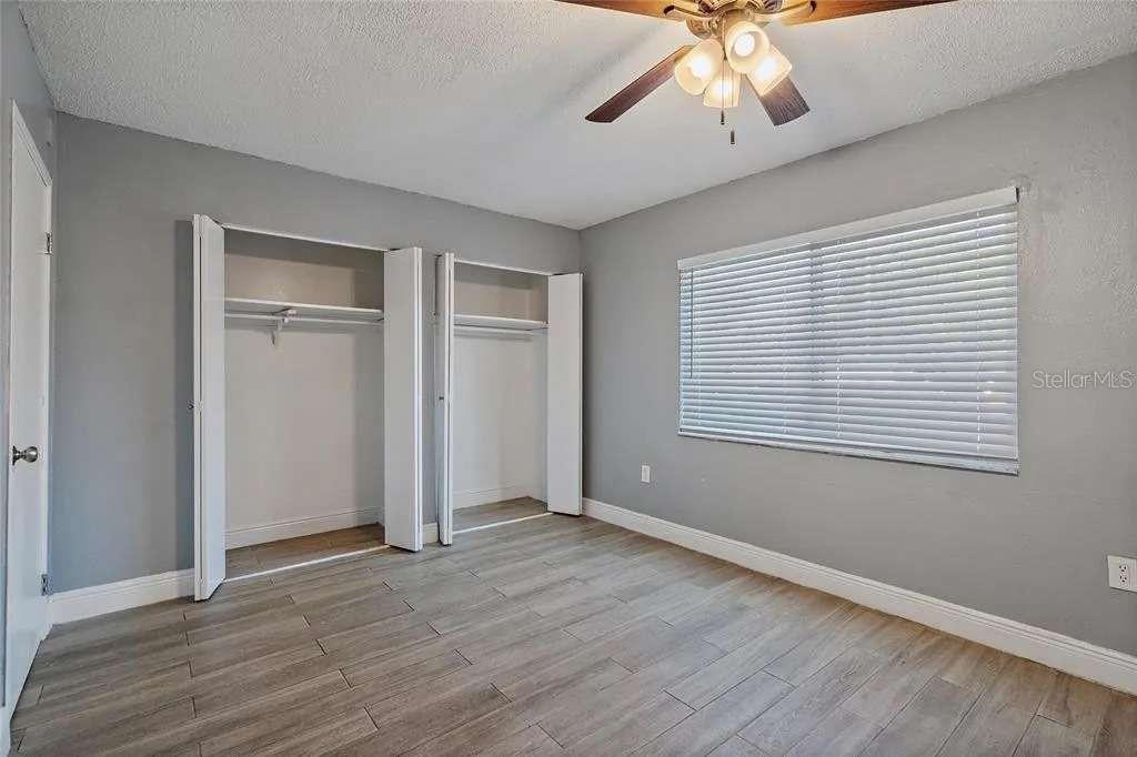 379 47th Avenue North, Unit 103 St. Petersburg, FL 33703 - Photo 24 of 24 a view of an empty room with wooden floor and a window