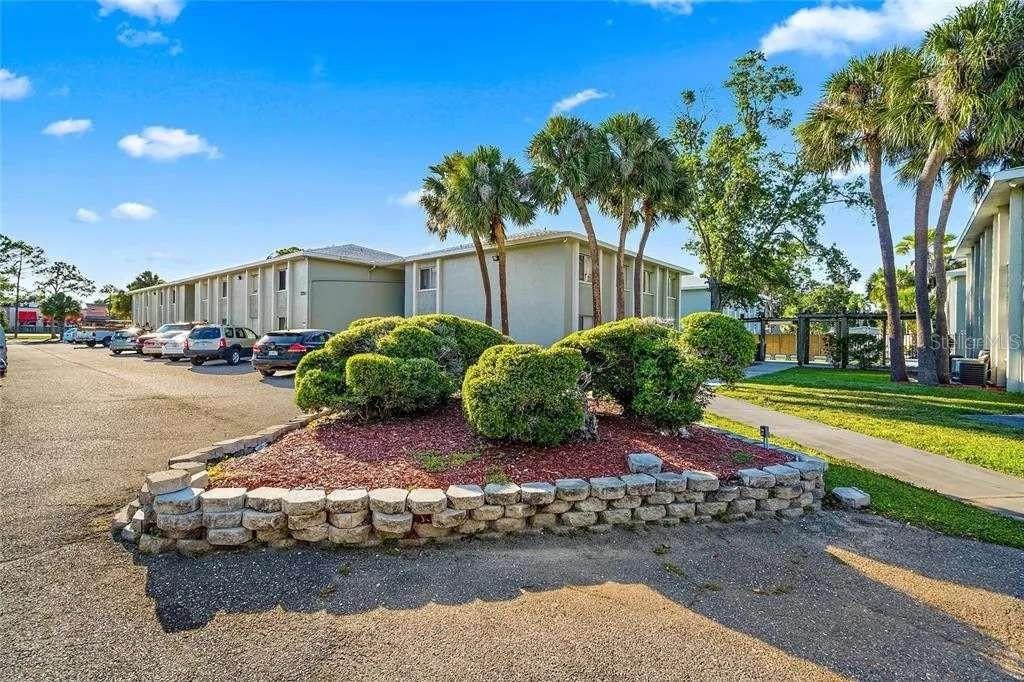 379 47th Avenue North, Unit 103 St. Petersburg, FL 33703 - Photo 3 of 24 a view of a house with a yard