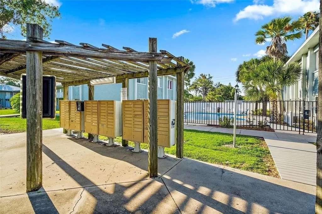 379 47th Avenue North, Unit 103 St. Petersburg, FL 33703 - Photo 4 of 24 a view of a patio with a table and chairs