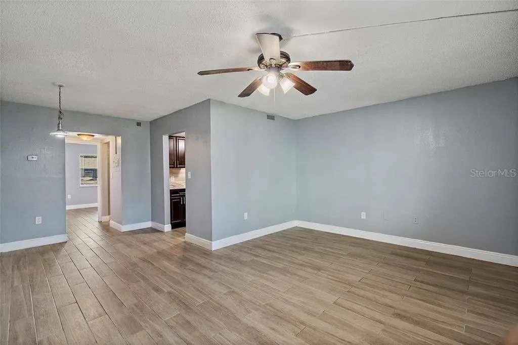 379 47th Avenue North, Unit 103 St. Petersburg, FL 33703 - Photo 6 of 24 wooden floor in an empty room with a window